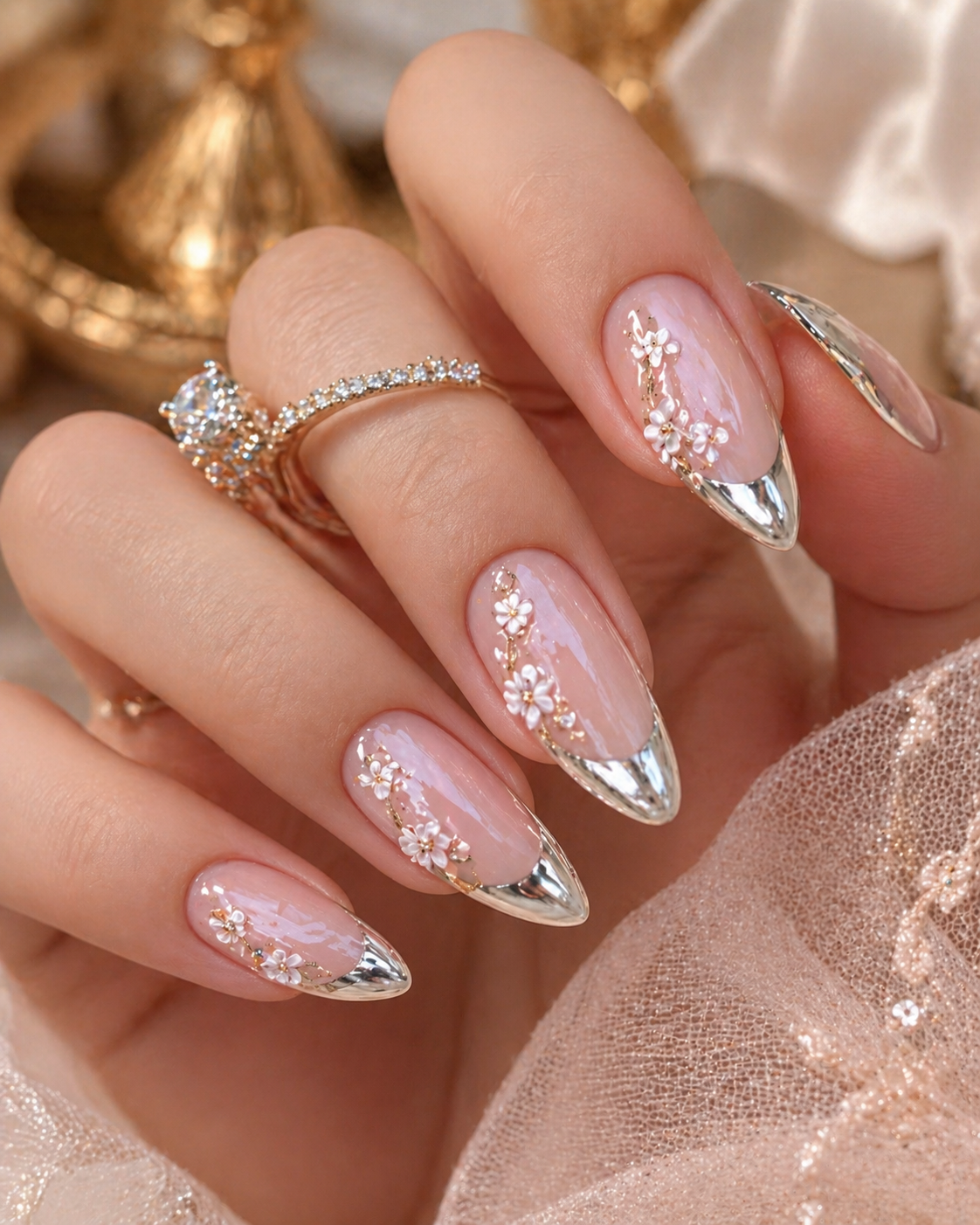 soft pink chrome nails with white floral nail art silver tips and gold details